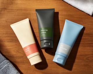Men's skincare starter kit with cleanser, moisturizer, and SPF on wooden surface